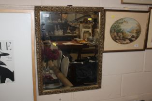 A gilt gesso framed bevelled glass wall mirror