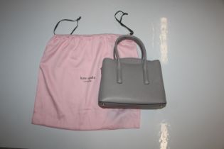 A Kate Spade grey evening bag with dust cover