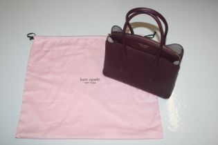 A Kate Spade wine leather evening bag with dust co