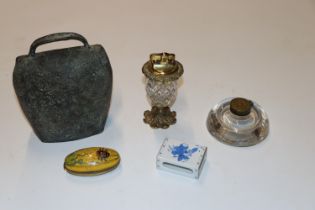 A cowbell, a halcyon days brass cut glass table lighter, a glass & brass ink well, a cloisonné box &