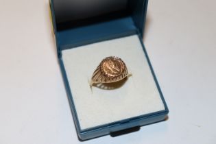 A 9ct gold ring inset with coin dated 1865 approx.