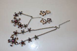 A white metal and coloured stone set necklace with