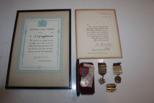 An imperial service medal in case with award docum