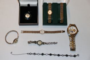 A box containing various wrist watches and a penda