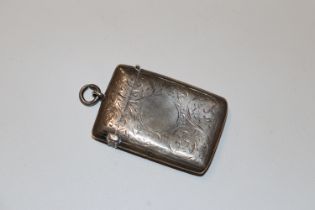 A silver vesta case with engraved decoration, vacant central cartouche hallmark Chester 1901 maker