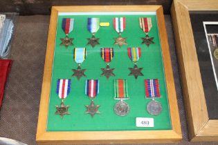 A frame of WWII medals, some WWII issue with some