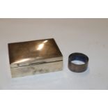 A silver cigarette box and a silver napkin ring ap