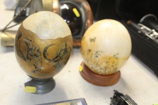 Two painted and decorated ostrich eggs