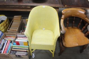A yellow painted Lloyd Loom armchair