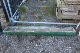 A six division green painted galvanised trough