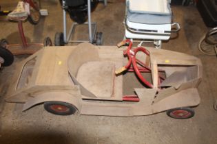 A wooden plyboard child's pedal kart