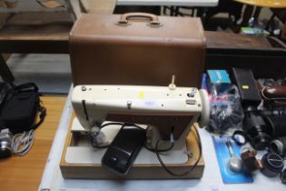 A Singer electric sewing machine within fitted cas