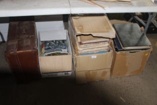 A vintage suitcase with contents and three boxes o