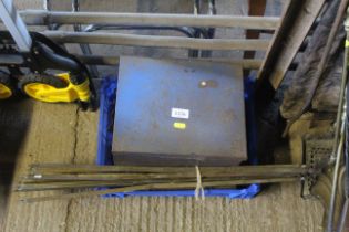 A quantity of stair rods, a metal storage tin and