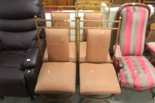 A set of four upholstered metal framed gold pained