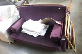 A purple upholstered two seater settee