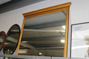 A large wooden framed overmantel mirror