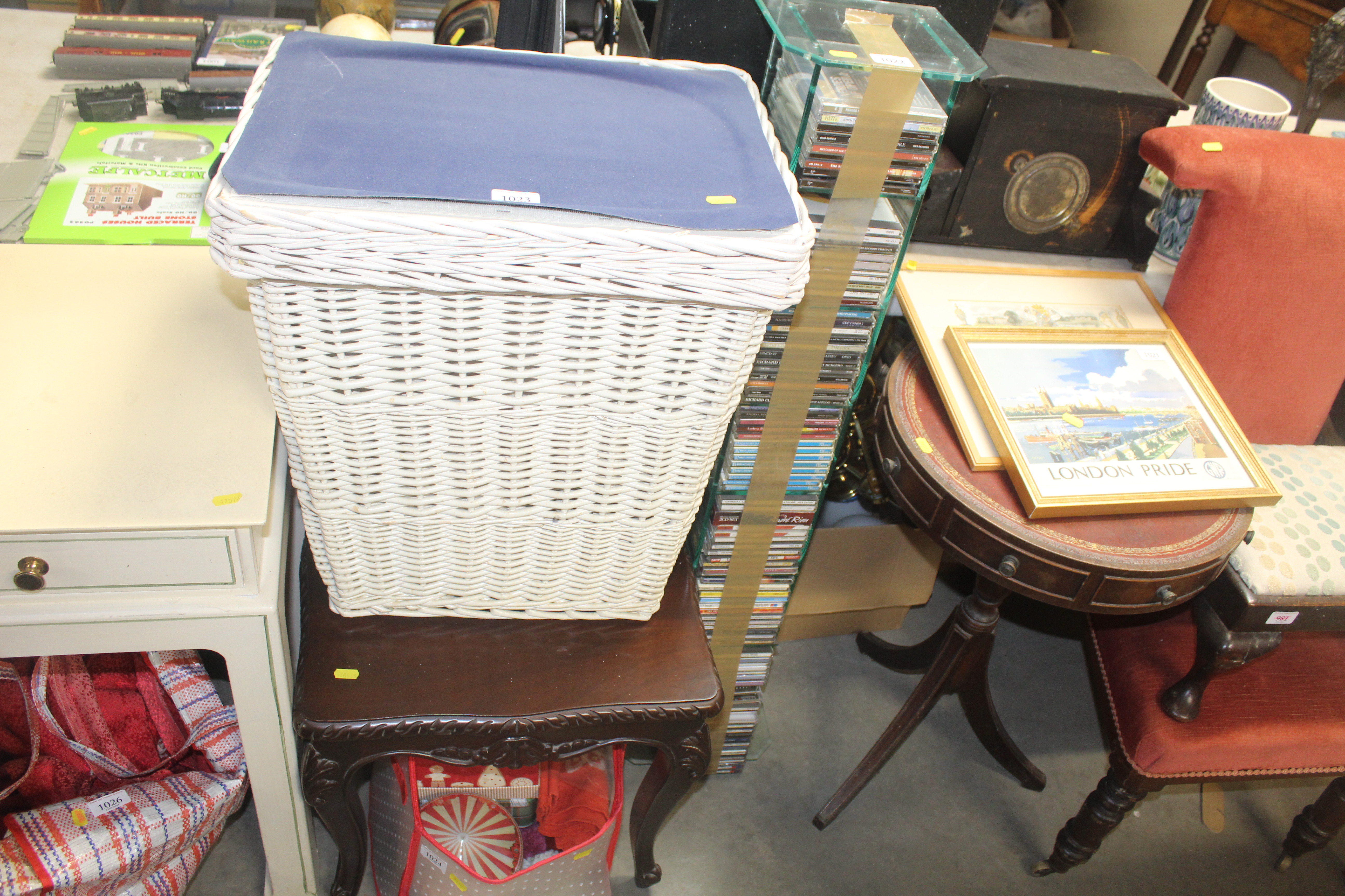 A wicker laundry basket and contents together with