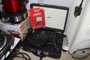 An Akai retro portable record player with instruct