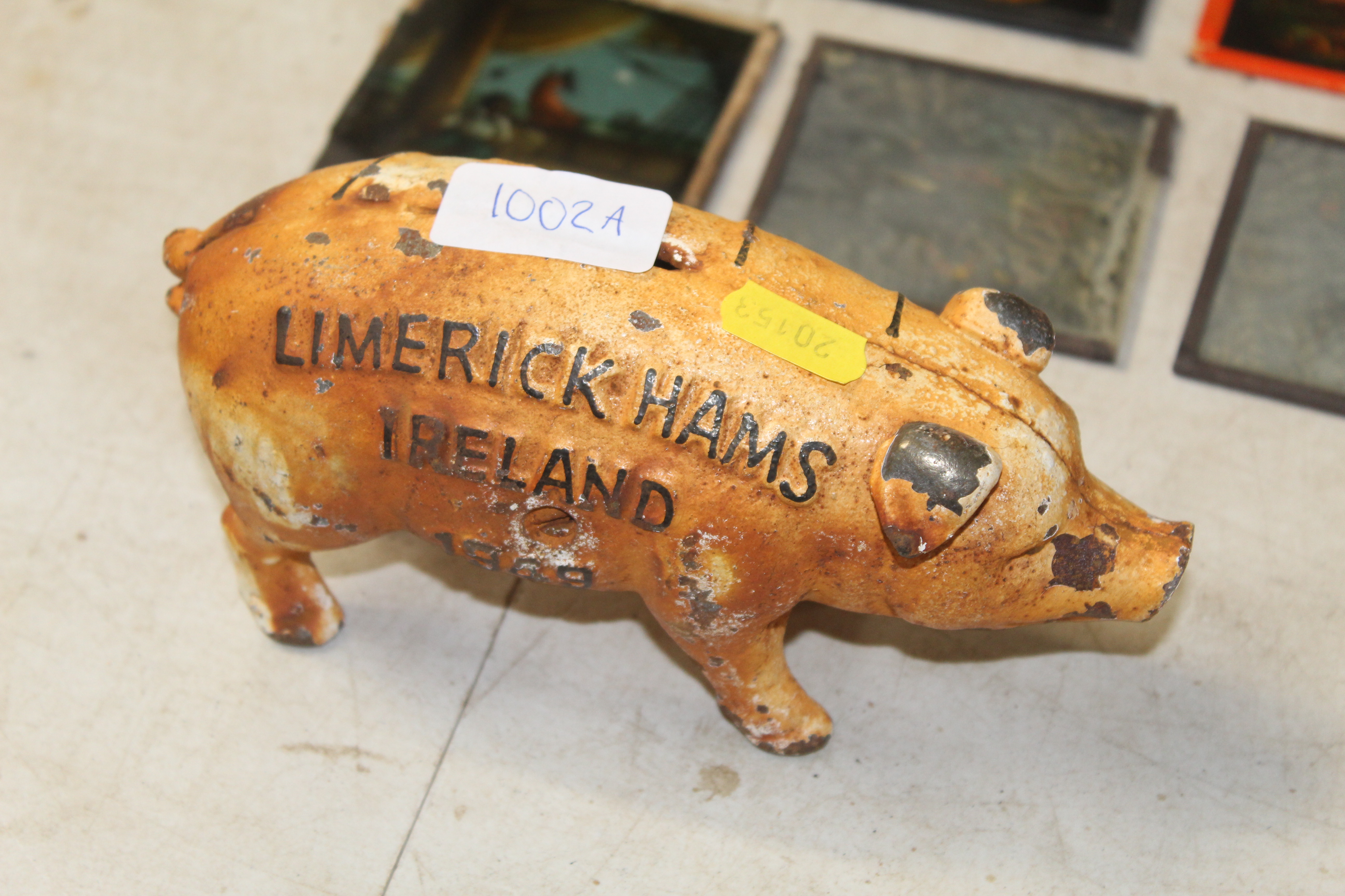 A novelty cast iron money box in the form of a pig