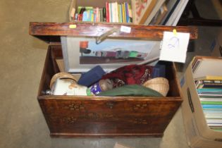 A wooden storage trunk containing miscellaneous it