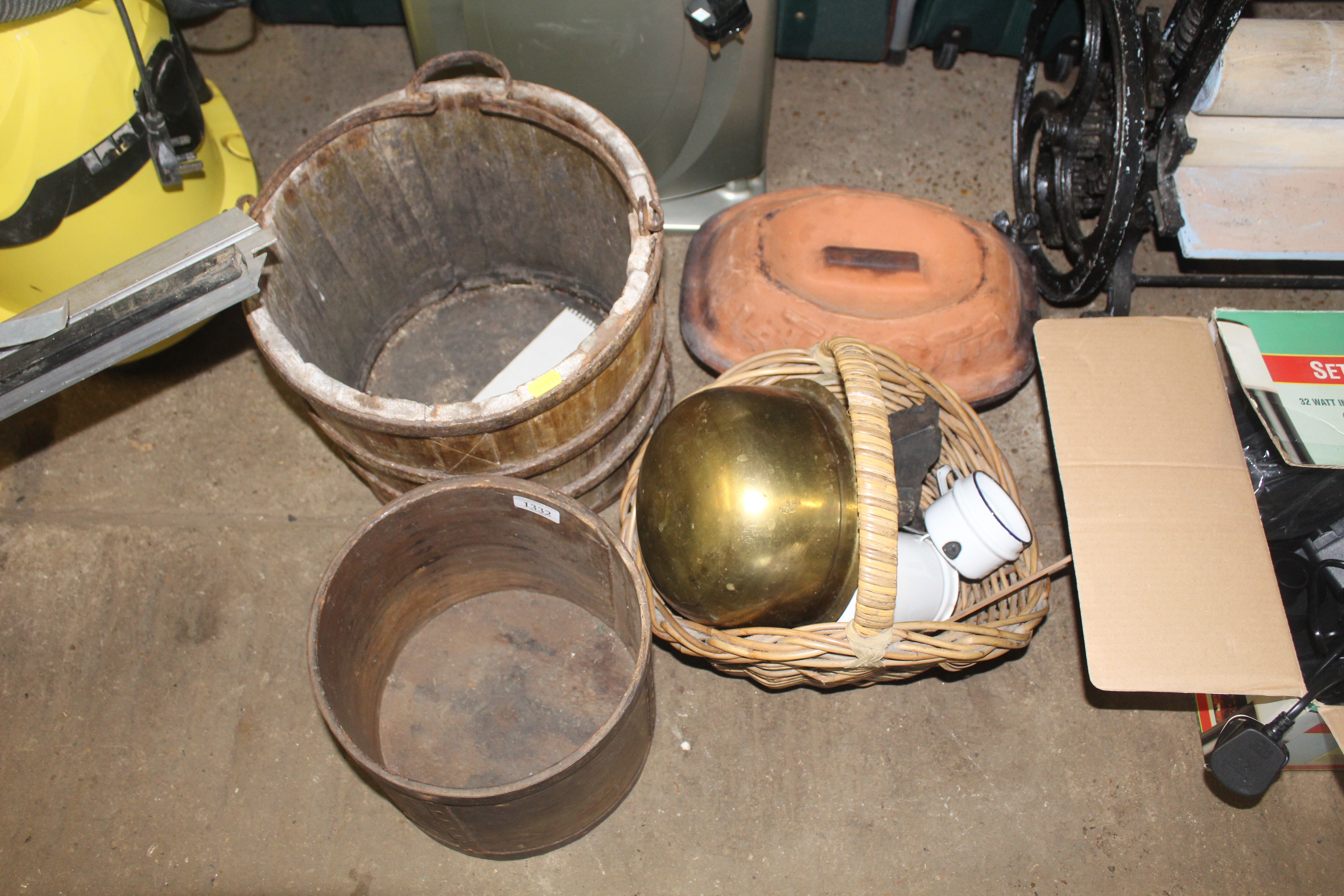 A wooden and metal bound bucket with iron swing ha