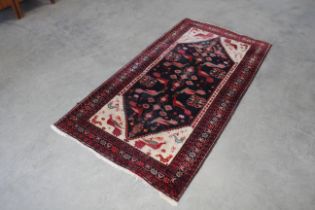 An approx. 7" x 3'8" red and blue patterned rug AF