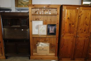 A tall pine open fronted bookcase