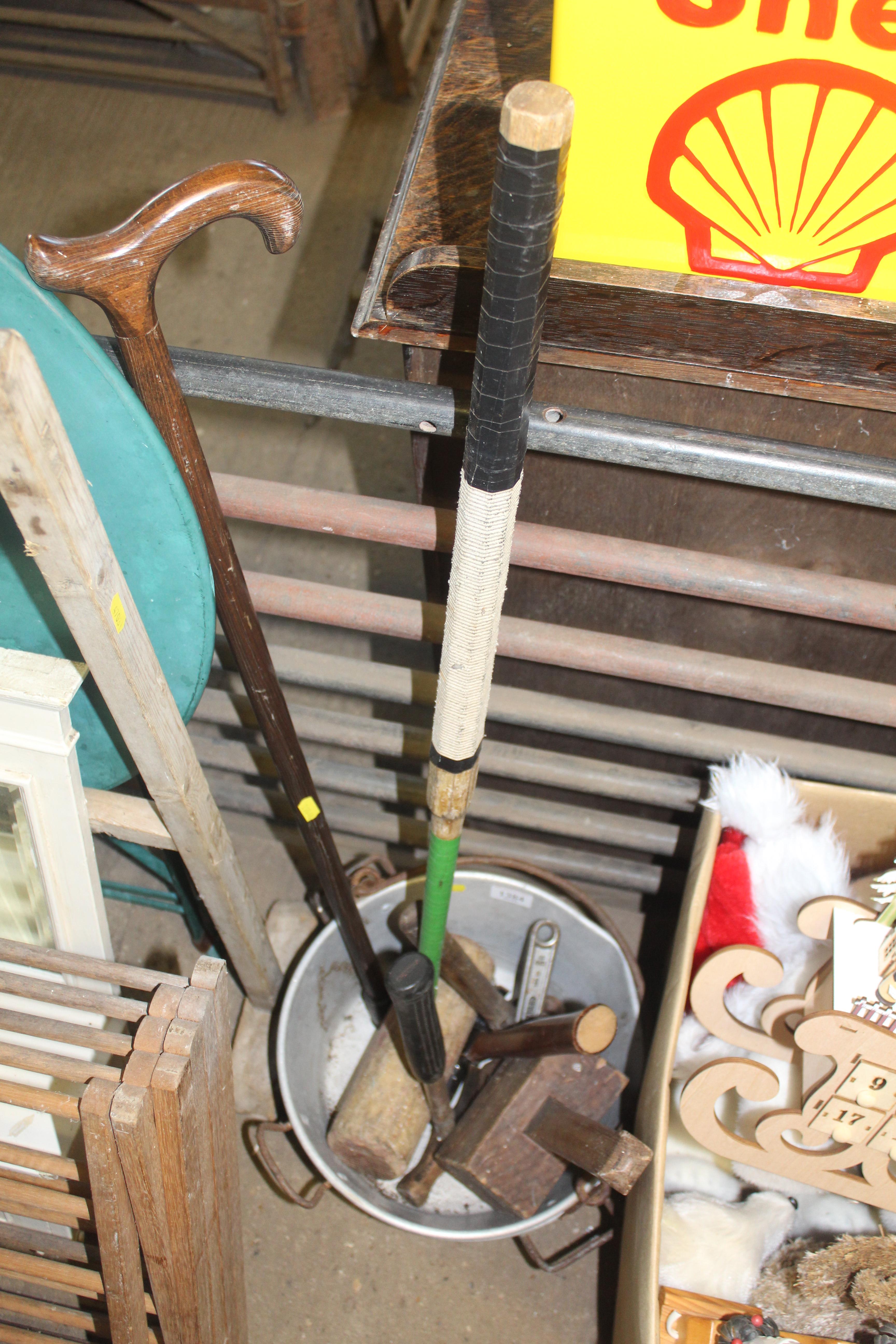 Two metal cooking pots, a walking stick, a mallet,