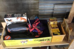 A box containing various pet related items to include dog training, chew toys and a further box of