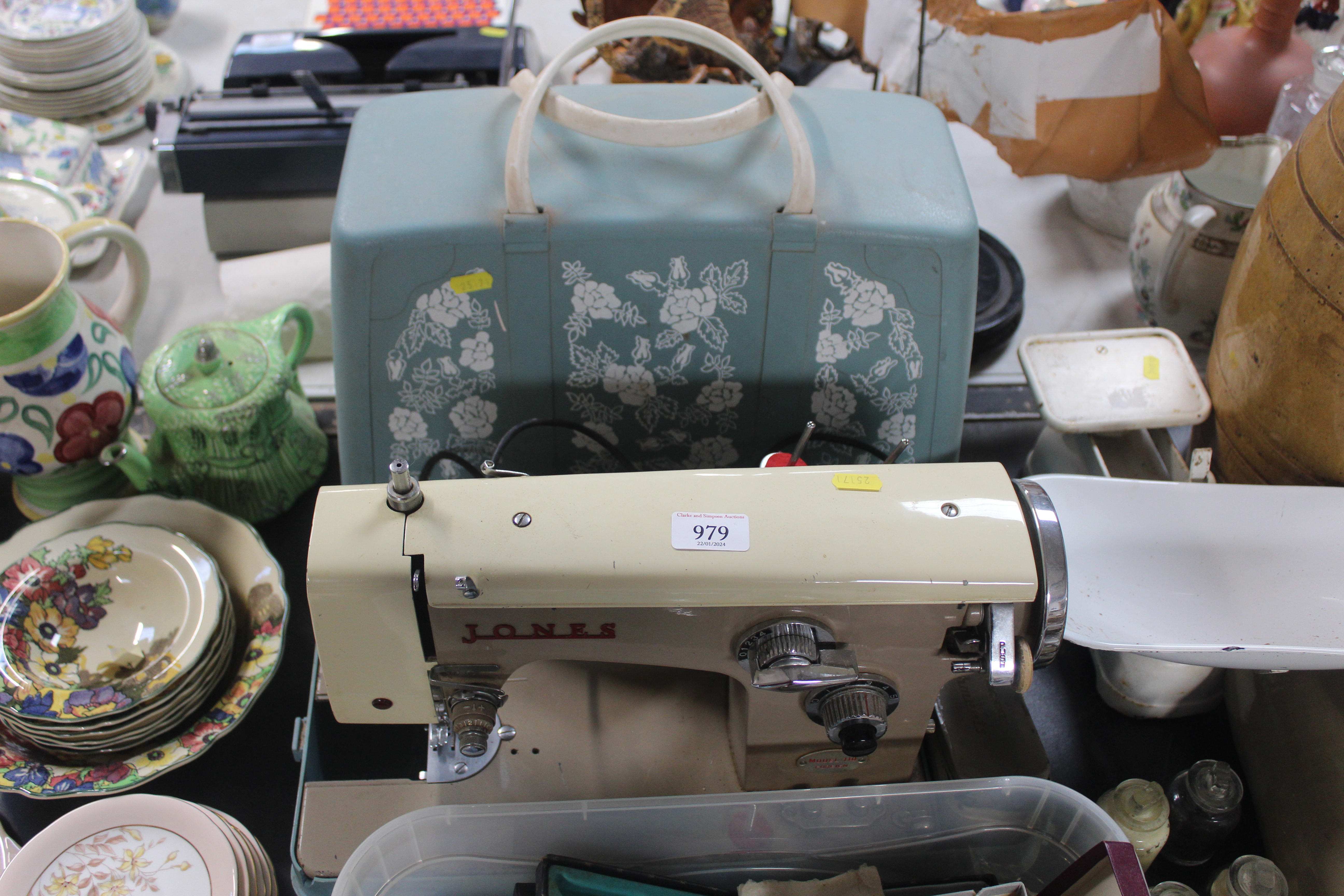 A Jones 110 electric sewing machine with case, sol