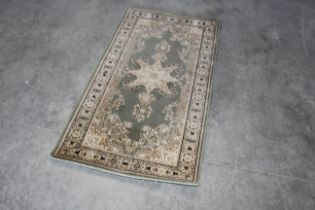 An approx. 5" x 2'8" green floral patterned runner