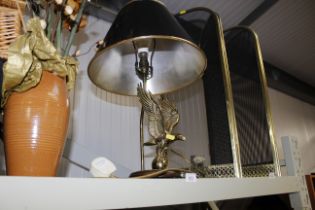 A brass table lamp with eagle motif
