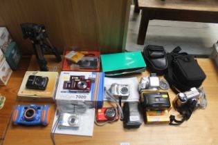 A quantity of various digital cameras including Ol