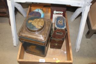 A wooden box and contents of various tins