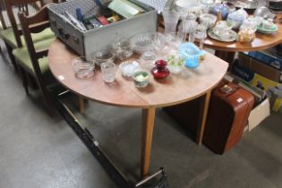 A circular drop leaf dining table