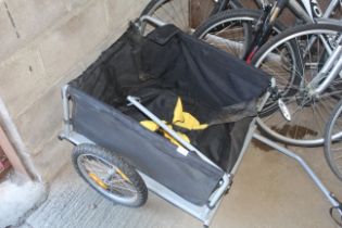 A folding single axle bicycle trailer