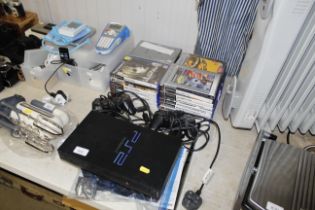 A PlayStation II with two controllers and