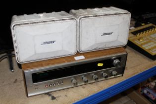 A Rotel RX-200A solid state AM/FM stereo receiver with pair of Bose Model 101 monitors