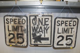 Three painted wooden highway signs: 'Speed Limit 2