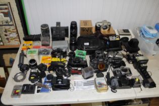 A large quantity of photographic equipment to include Olympus cameras, Nikon camera, Konica