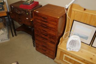 A Continental hardwood eleven drawer chest