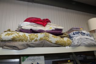 A quantity of various blankets, pillows, material