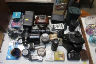 A large quantity of various cameras and lenses to
