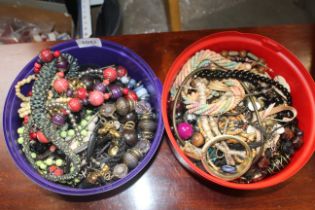 Two plastic tubs of various costume jewellery