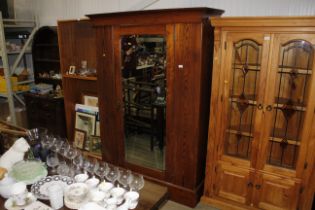 A pitched pine mirror door wardrobe