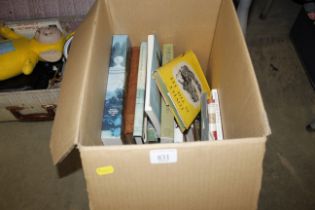 A box of various paperback and hardback books