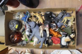 A box containing glass fruit and toy animals