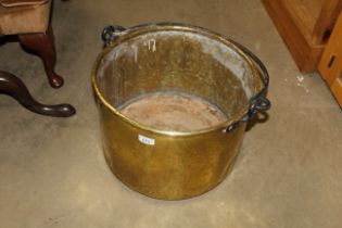 A large brass bucket with iron swing handle