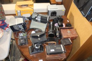 A quantity of various cameras to include Kodak, Canon, an Okay 100 camera with original box, various